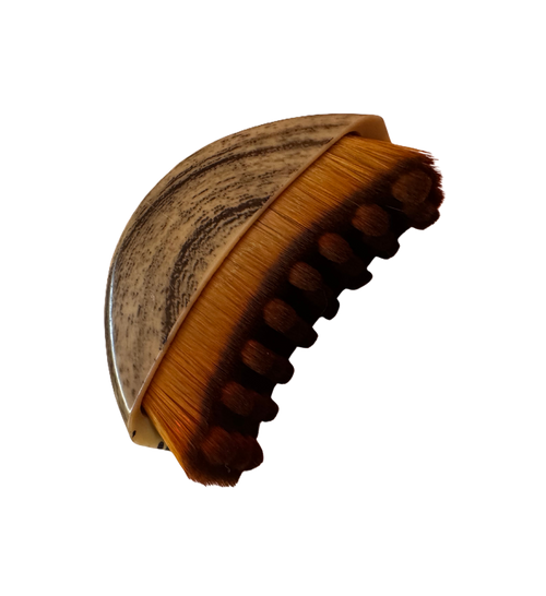 Wooden facial drainage brush with brown bristles on a white background