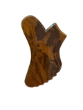 Mookaite Gua Sha stone with a unique shape on a white background